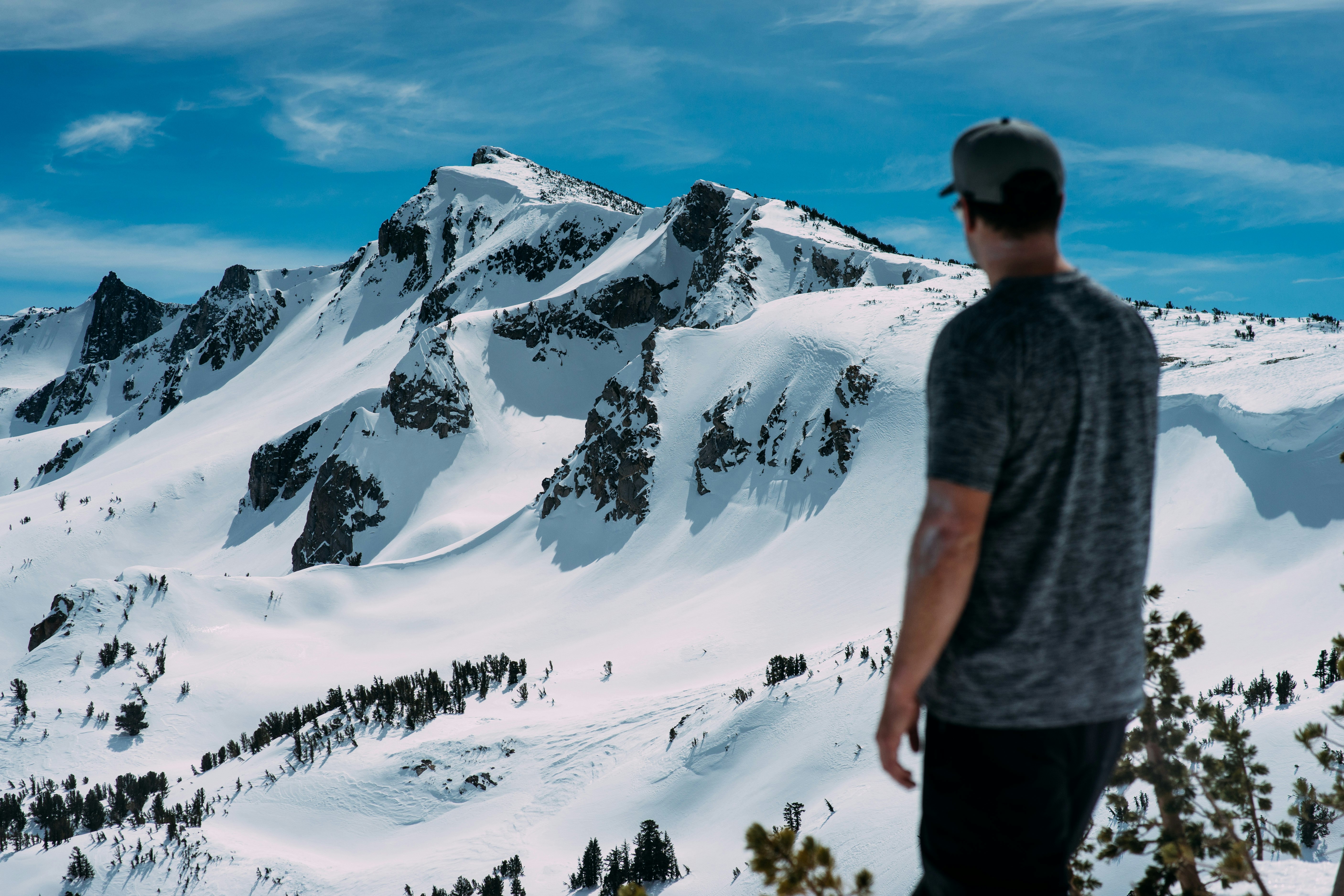 man looking at snow mountain